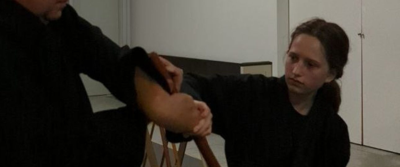 Man and young woman practicing bojutsu bostaff martial art training