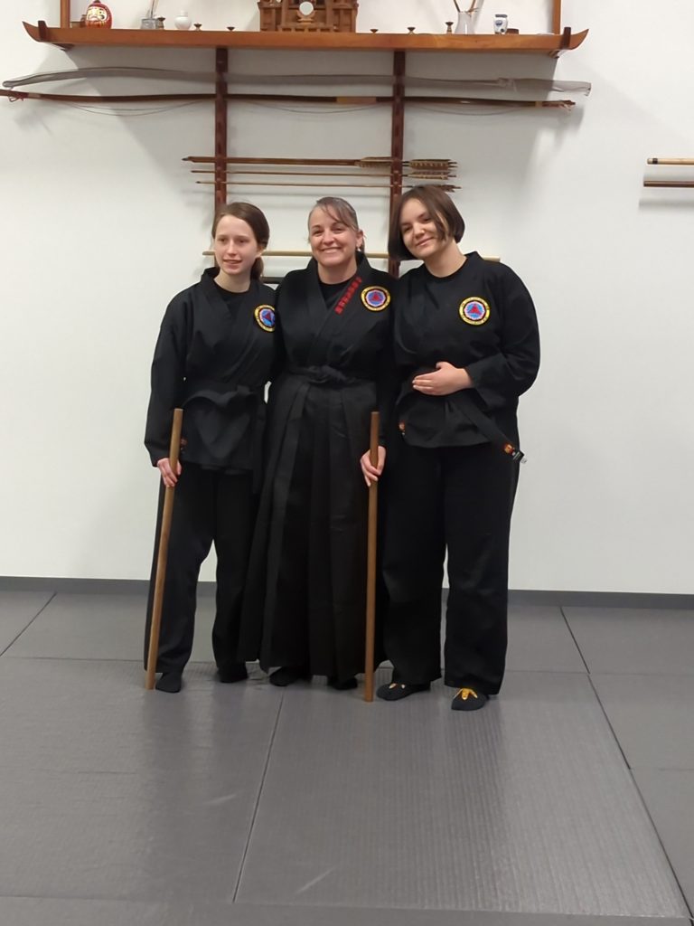 2 young women martial artists with their female instructor